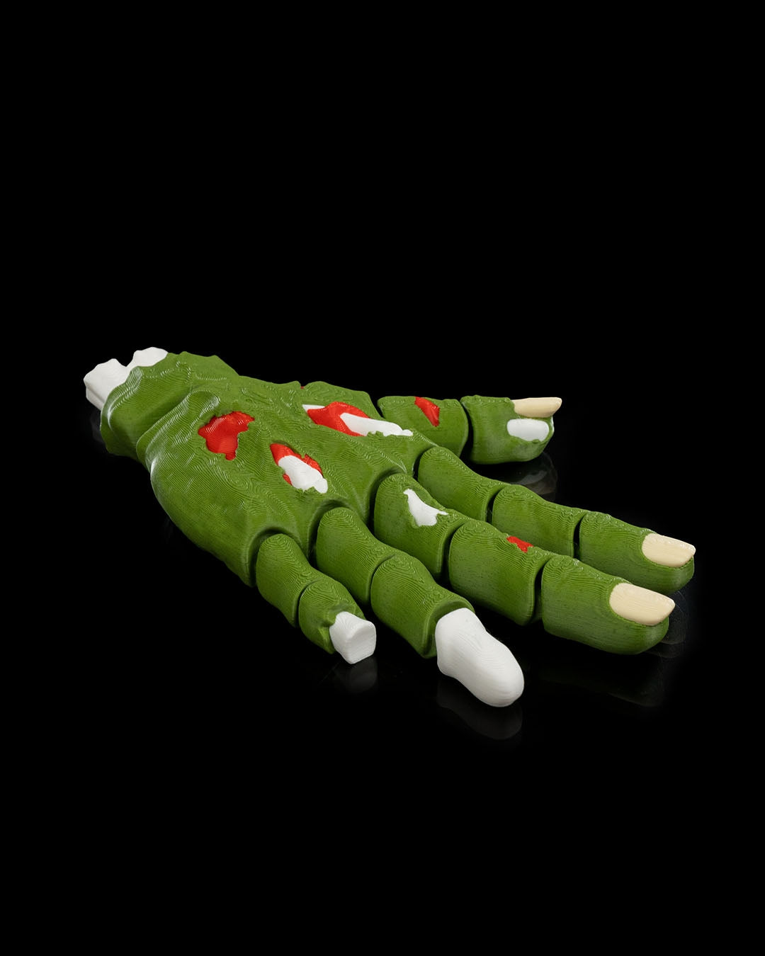 Handy Deadman mana zombie verde intinsa lateral, fundal negru