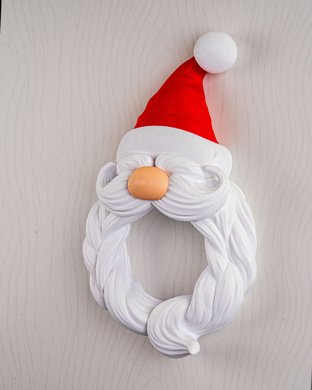 Coroană decorativă cu chip de Moș Crăciun, 22 cm