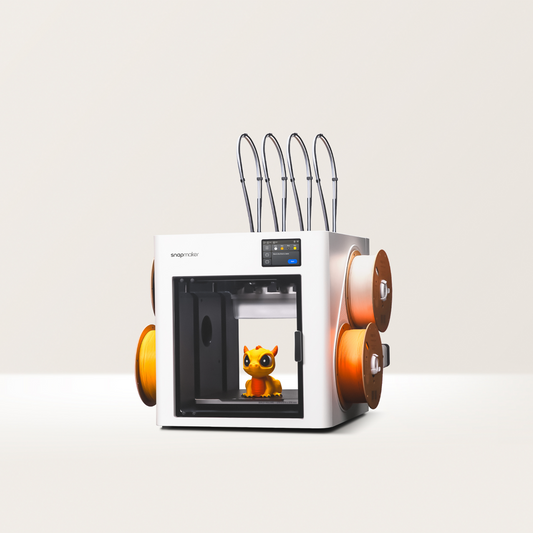 Snapmaker U1 – vedere frontală cu filamente portocalii
